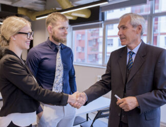happy-business-people-shaking-hands-after-finishing-up-meeting